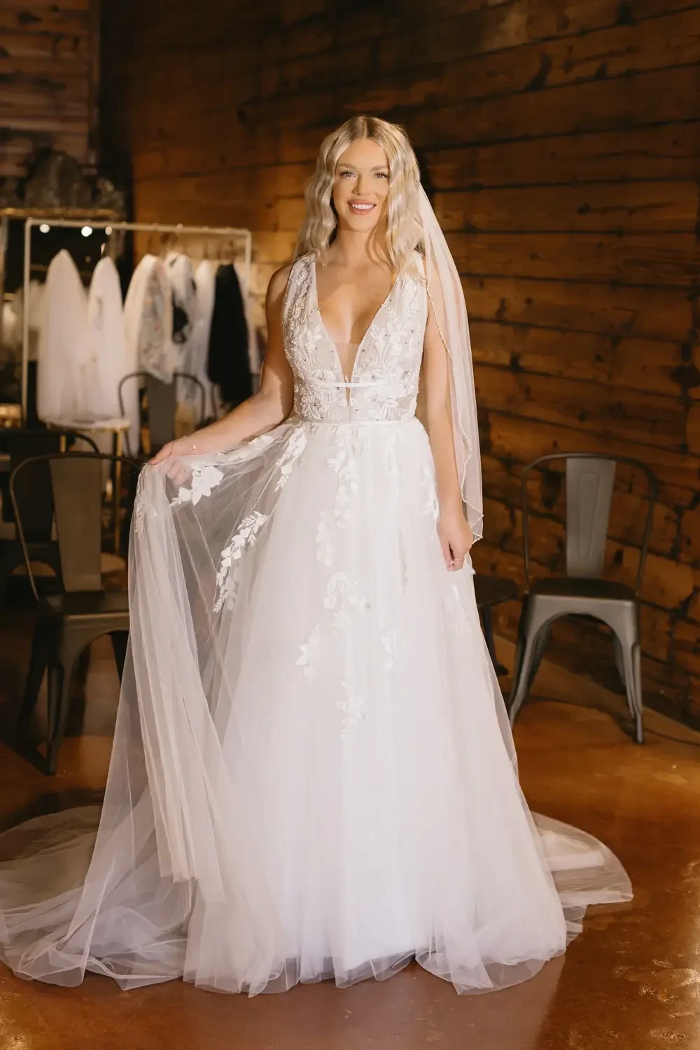 model is wearing a sleeveless a-line bridal gown