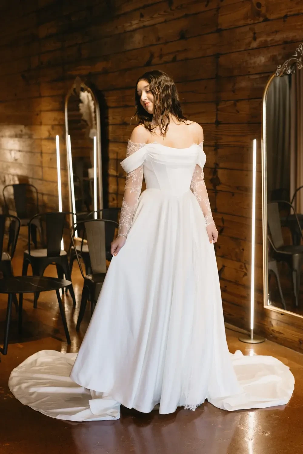 model is wearing a off the shoulder bridal gown